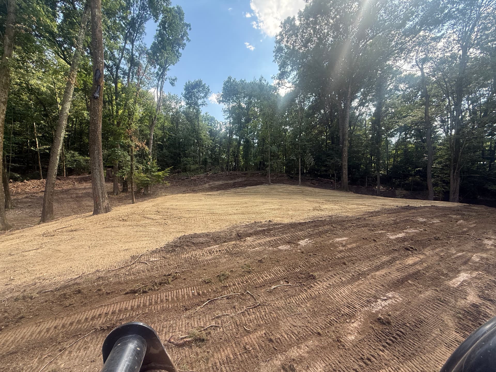 Rough Wooded Ground Cleared Into a Large, Level Usable Space image